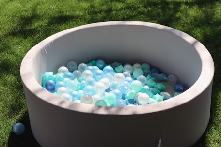 a large bowl filled with lots of blue and white balls