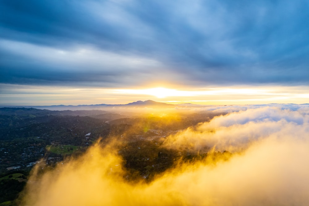 an aerial view of a city surrounded by clouds