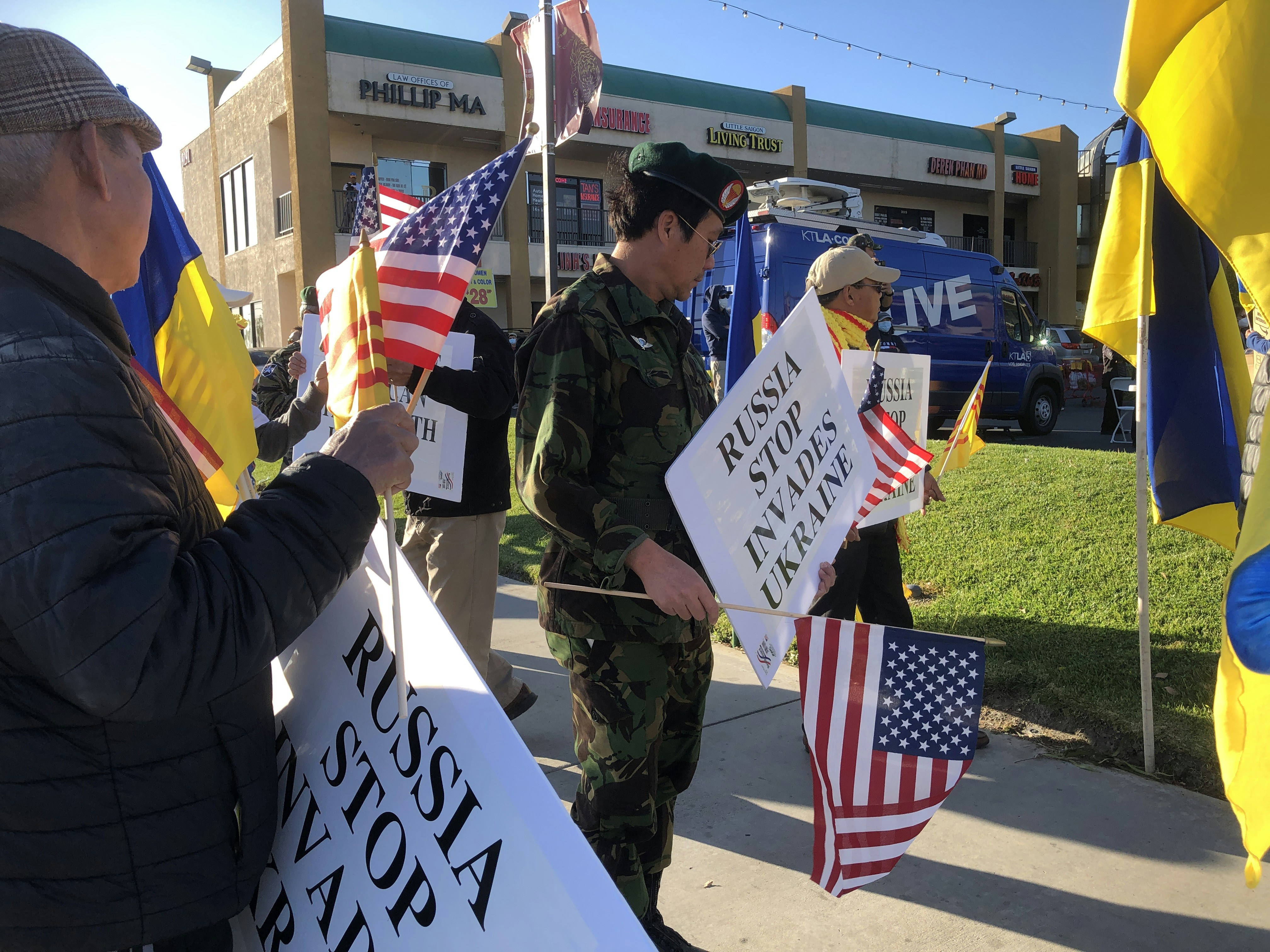 a group of people holding flags and signs