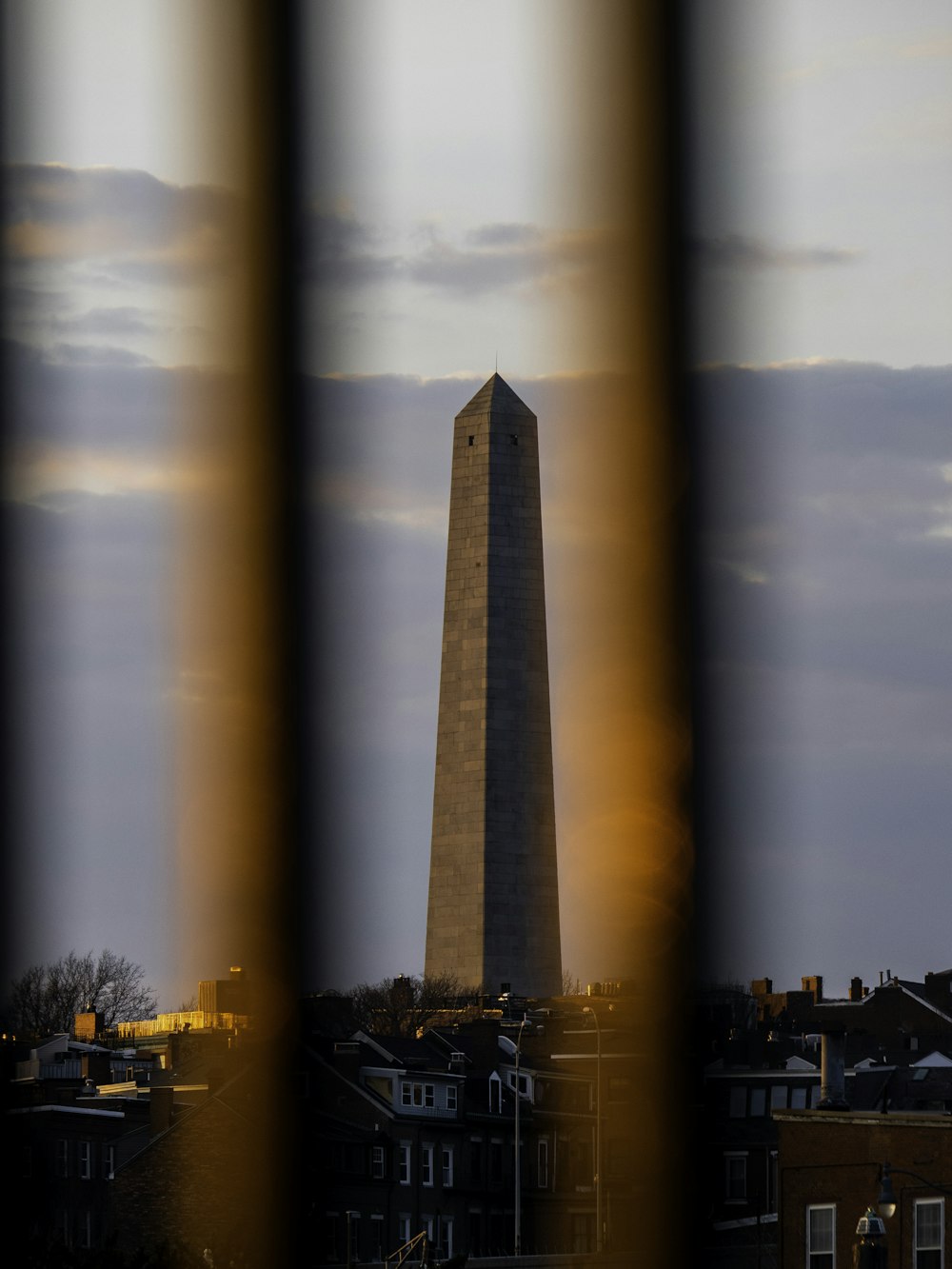 a view of the washington monument through a fence