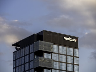 a very tall building with a verizon sign on top