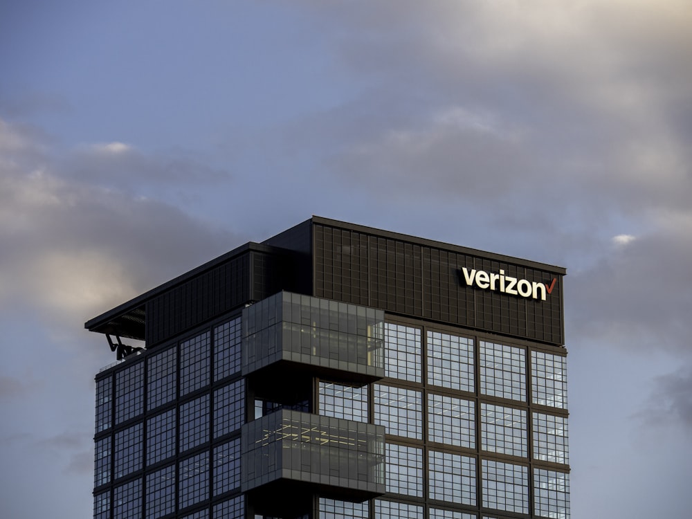 a very tall building with a verizon sign on top