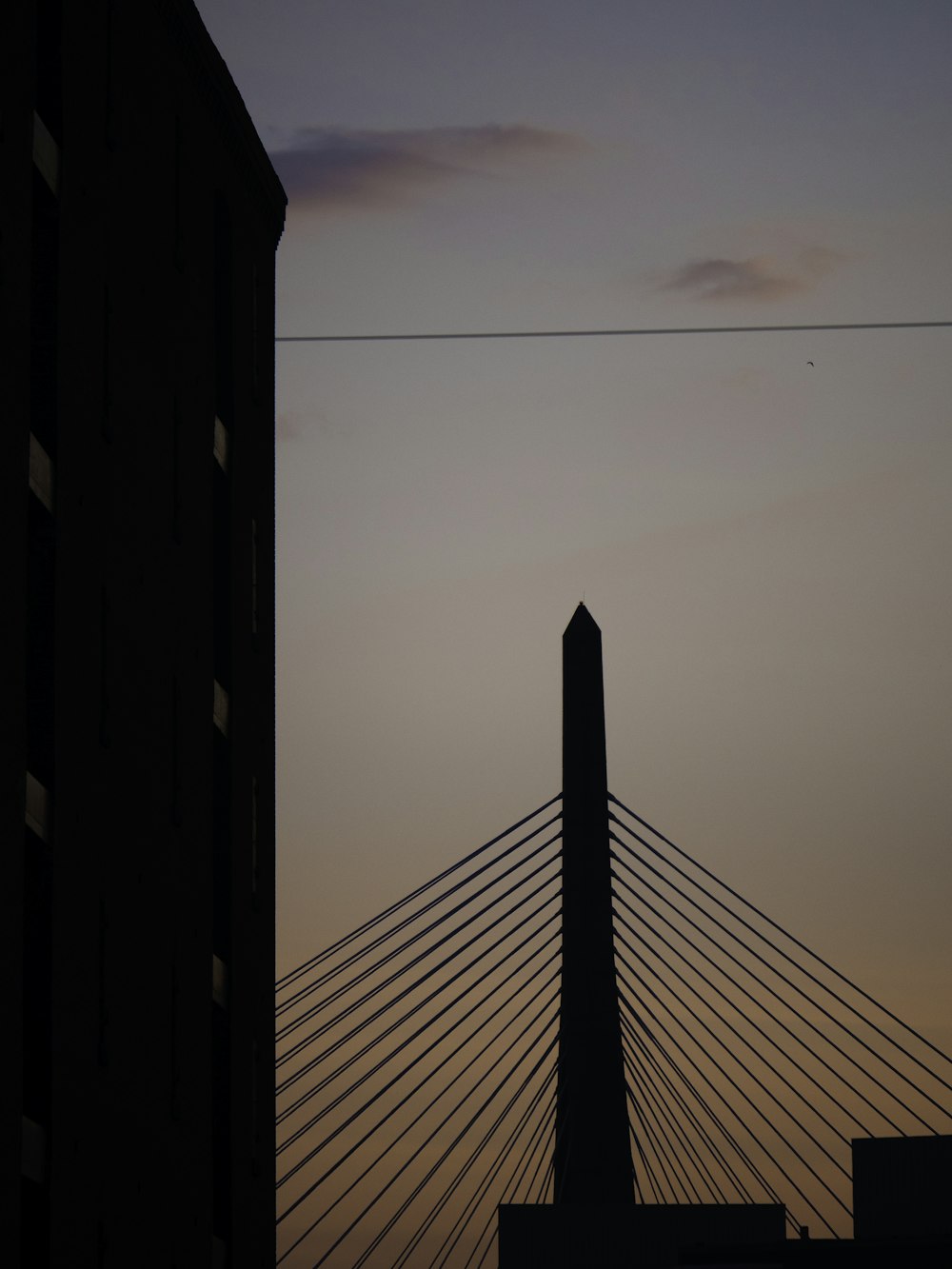 a very tall bridge with a very tall building in the background