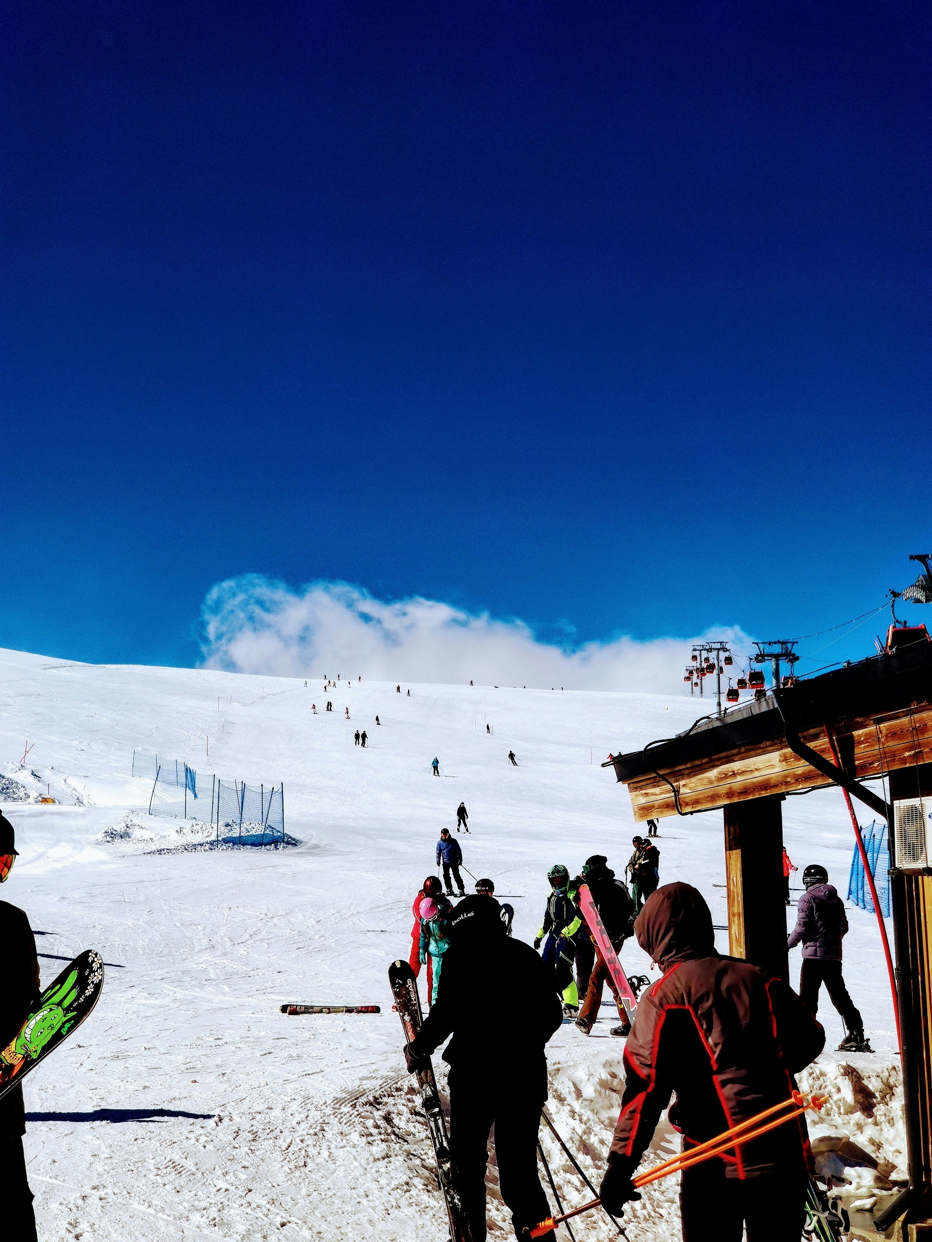 a group of people standing on top of a snow covered slope