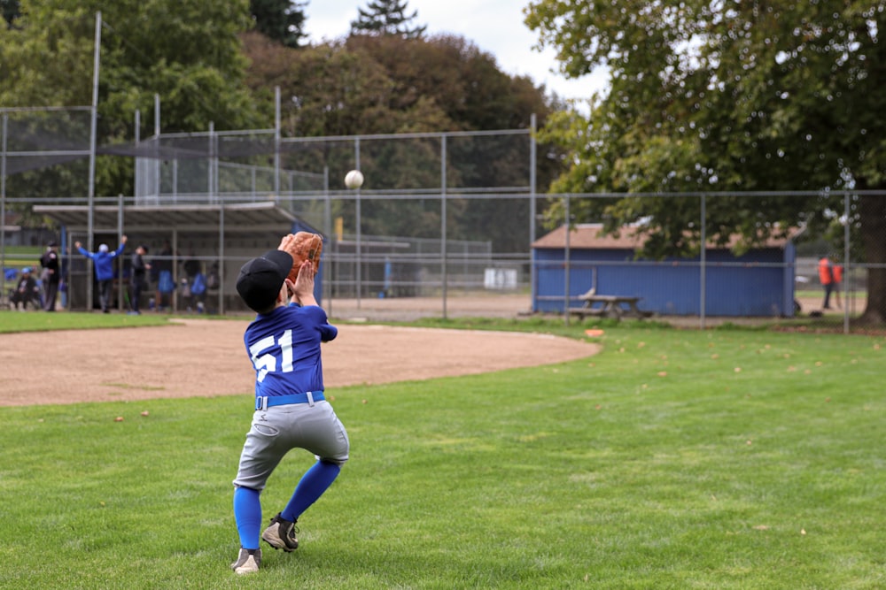 a baseball player catching a ball on a field