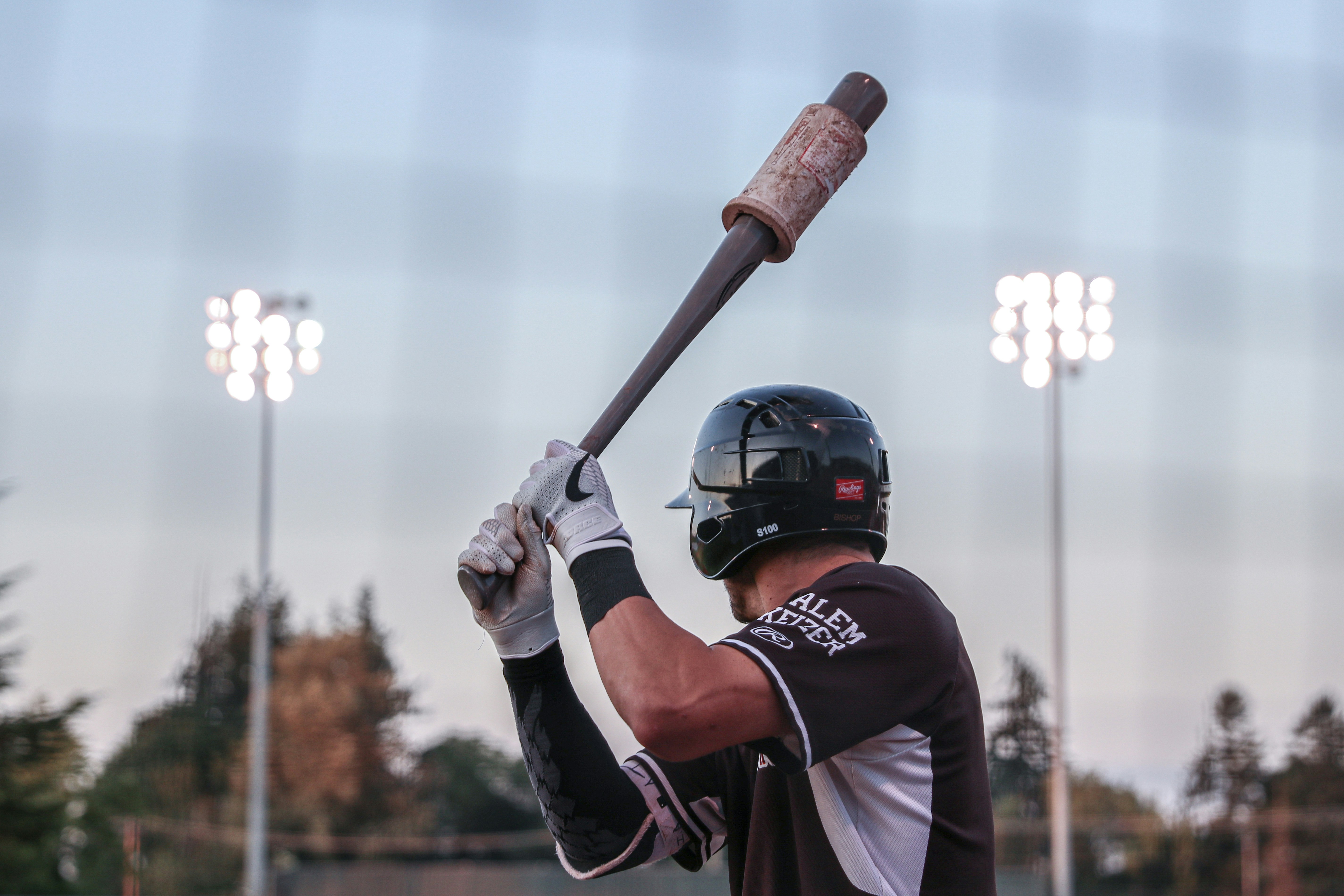 Professional baseball player on deck at a game with bright lights