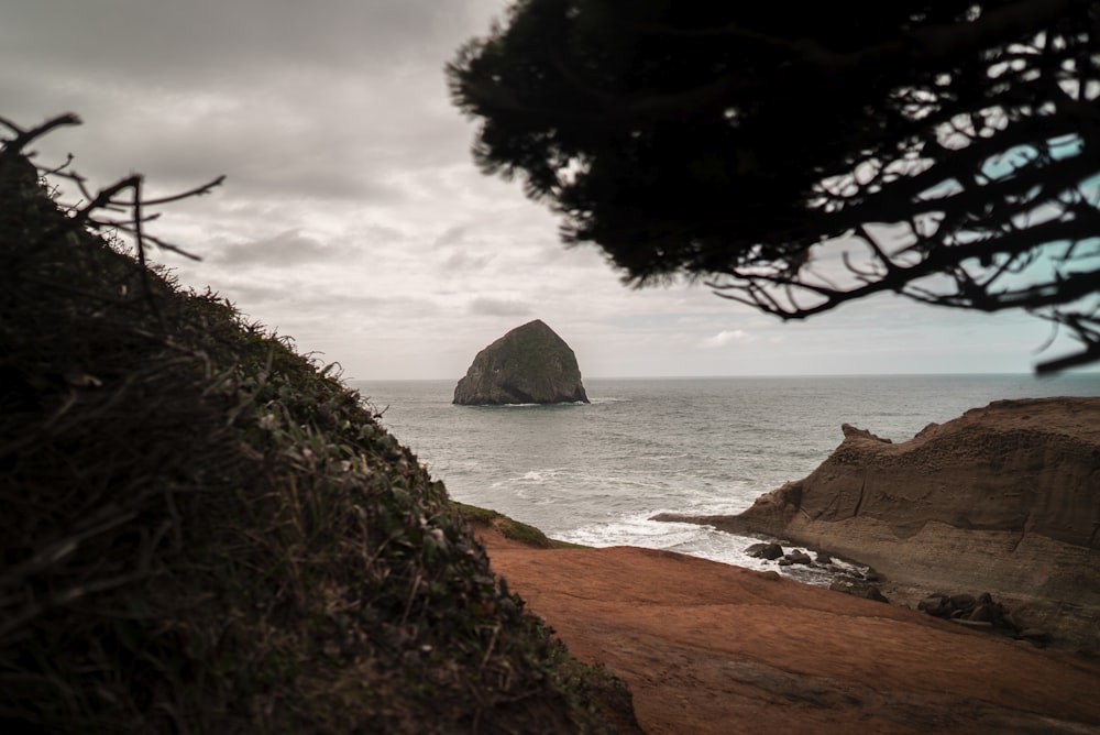 a rock outcropping in the middle of the ocean