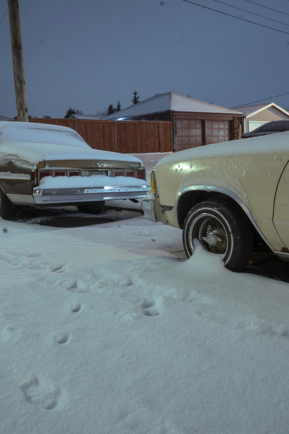 a car parked in the snow next to another car