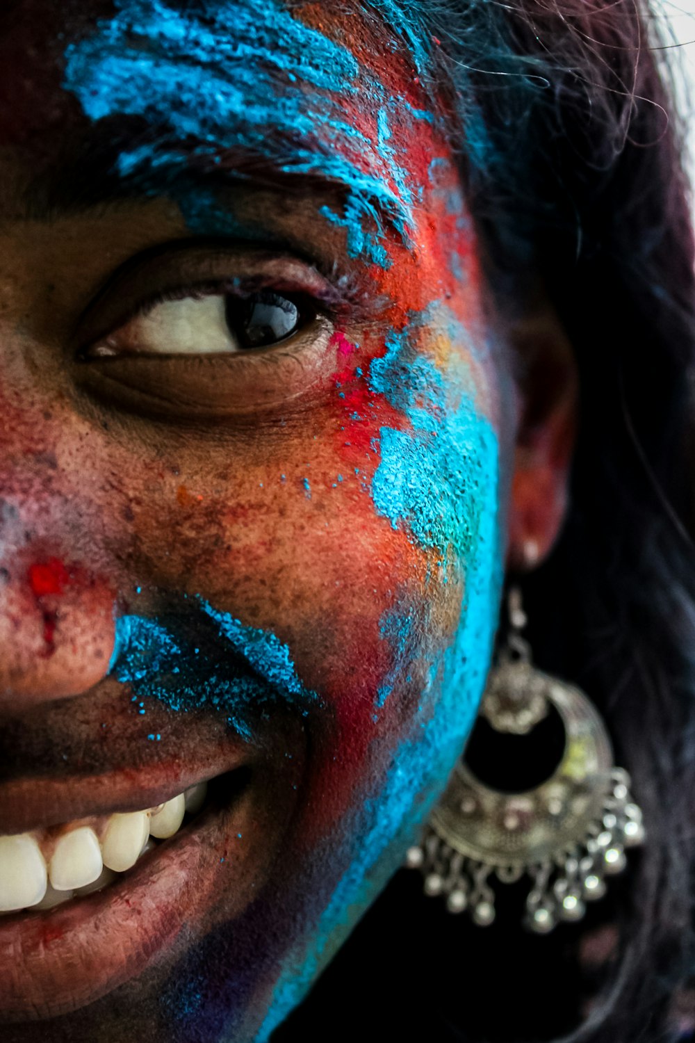 a woman with blue and red paint on her face