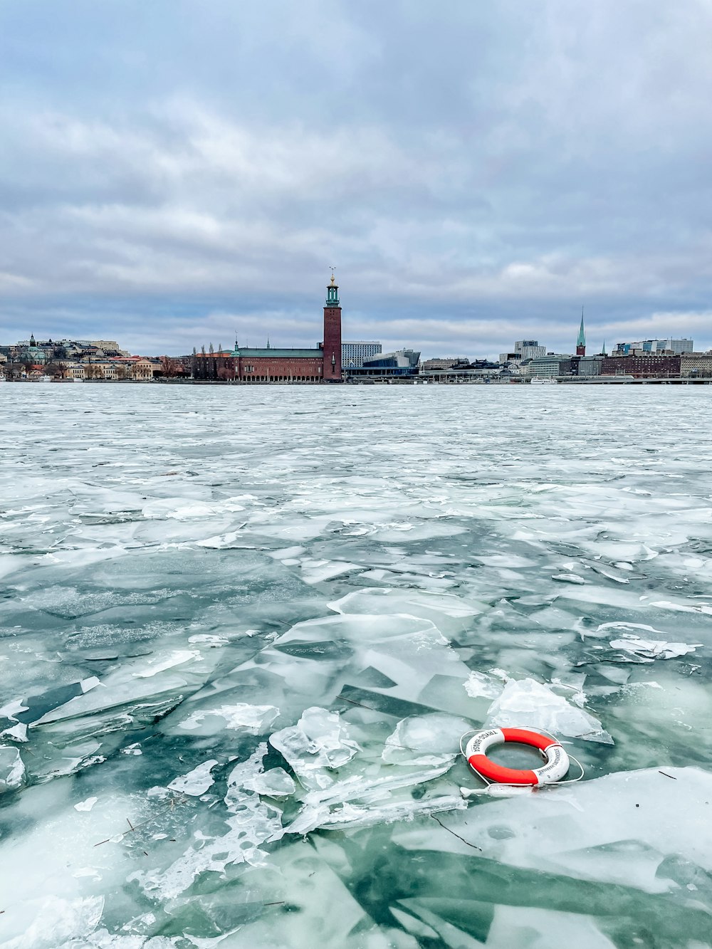 a red life preserver floating on top of a body of water