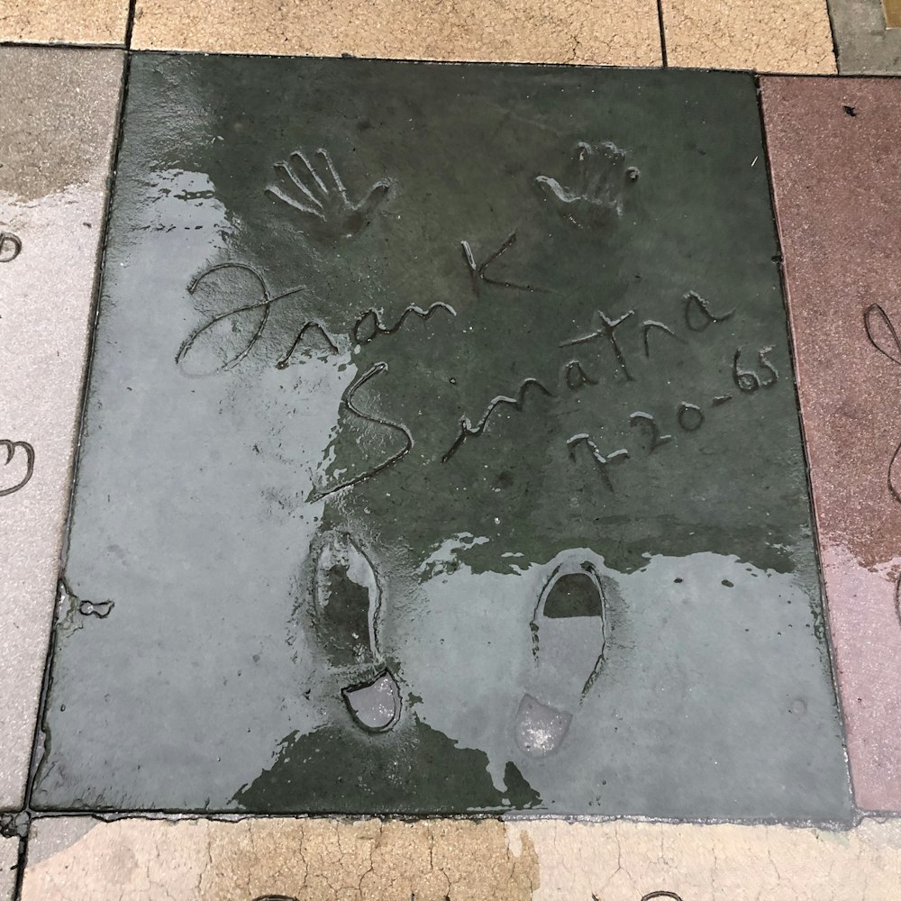 a close up of a sidewalk with writing on it