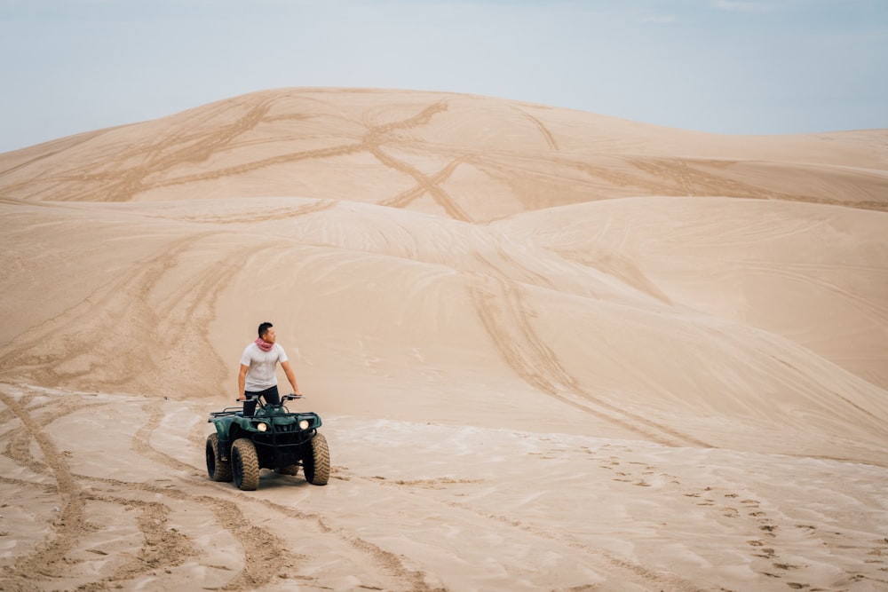 a man riding a four wheeler in the desert