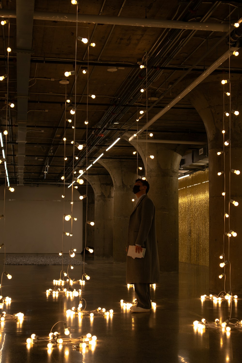 a man standing in a room with lots of lights