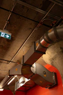a street sign hanging from the ceiling of a building