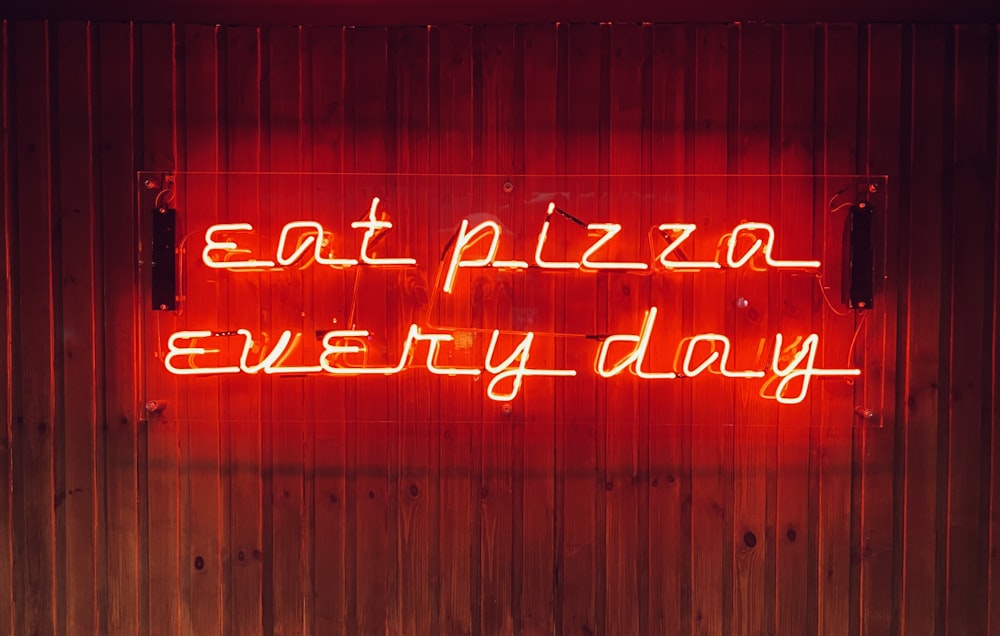 a neon sign that says eat pizza every day