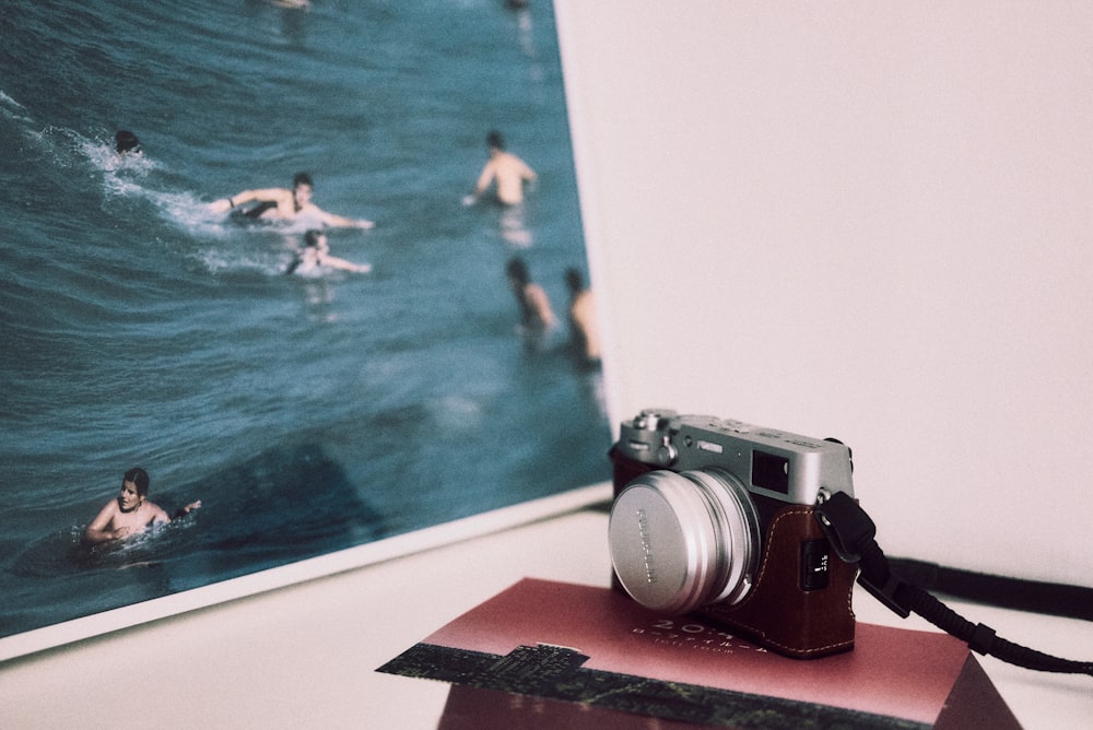 a camera sitting on top of a table next to a picture