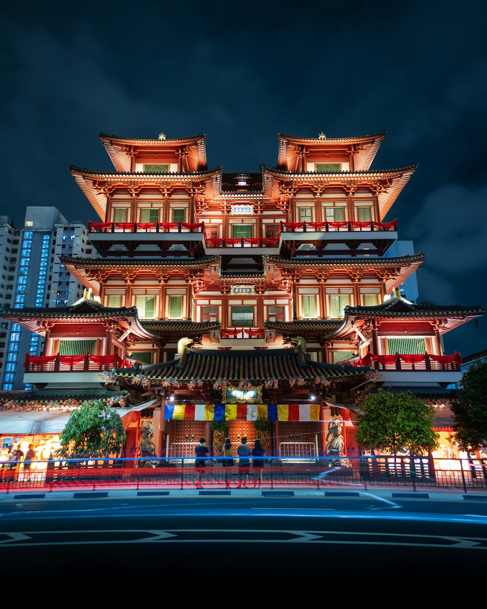 a tall building lit up at night in a city