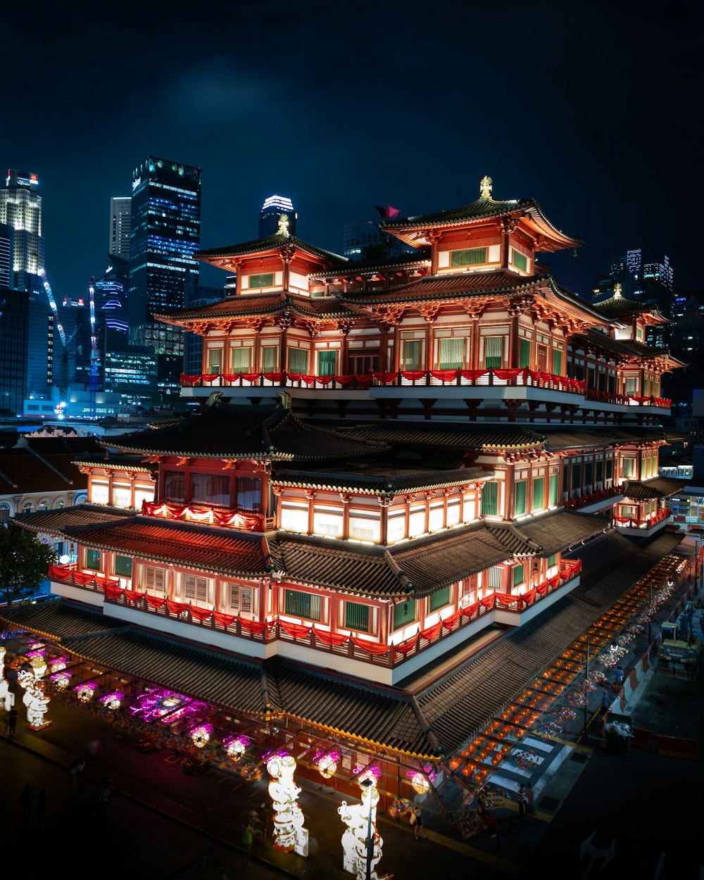 a chinese building lit up at night in the city