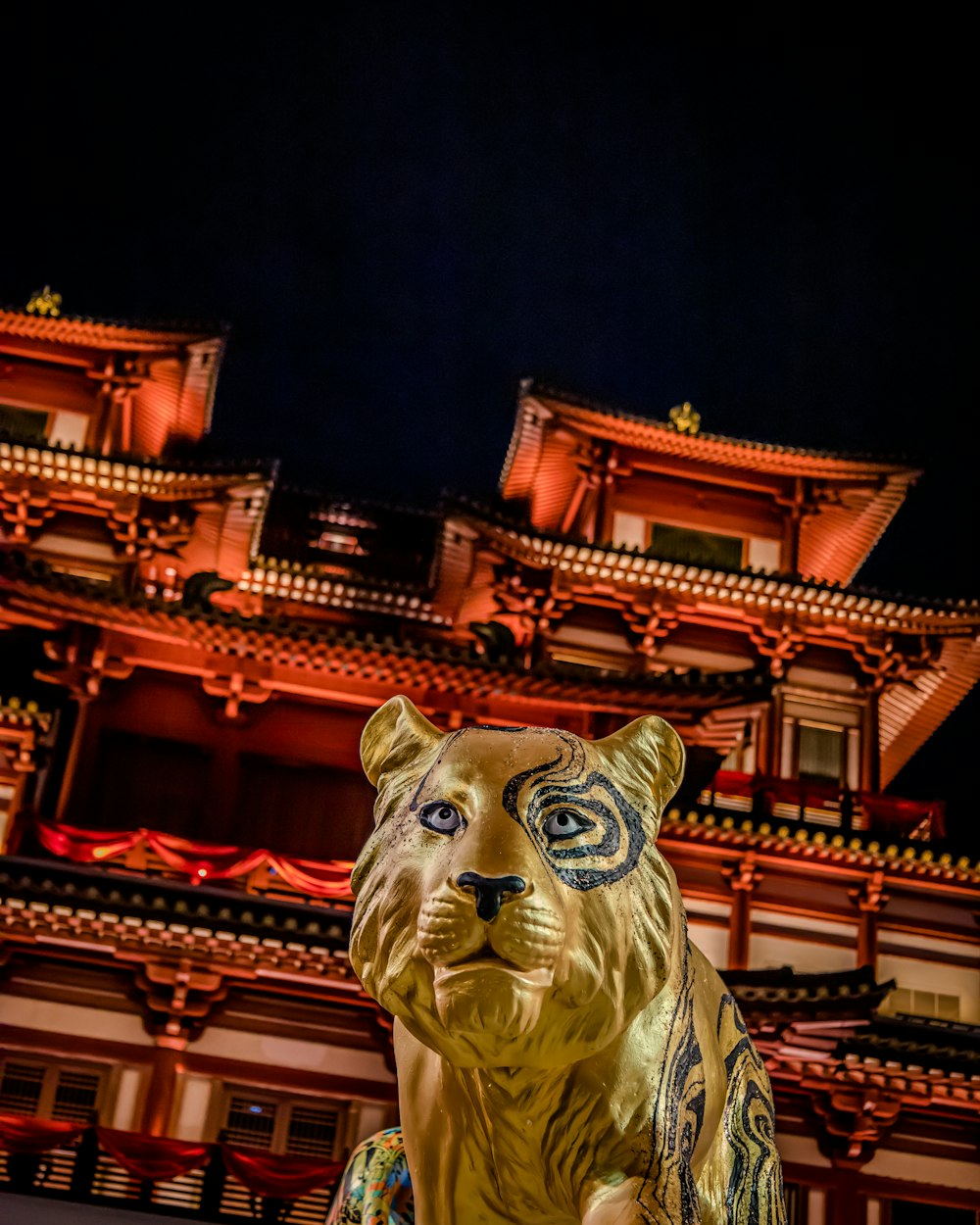 a statue of a bear in front of a building