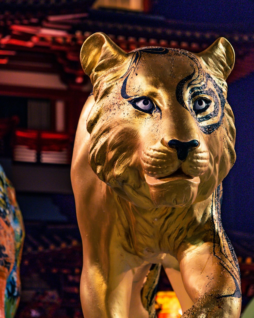 a statue of a tiger in front of a building