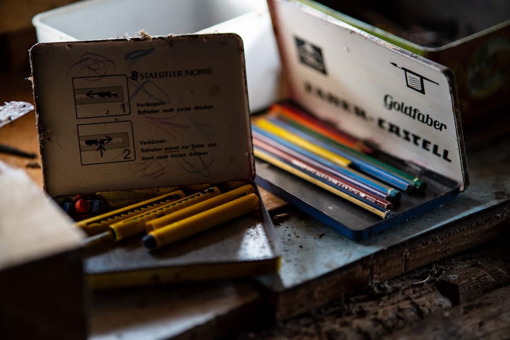 a box of pencils sitting on top of a table