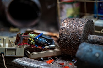 A close-up of various electronic waste items piled together.