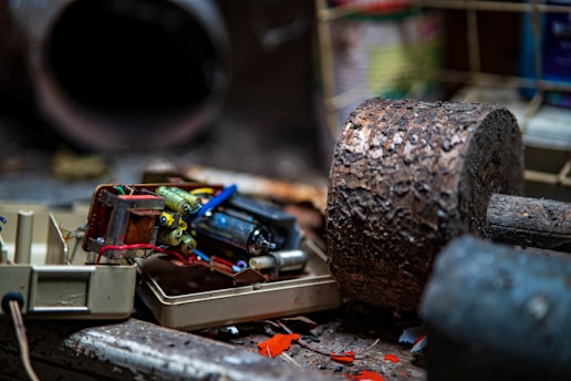 A vintage logic probe resting on a weathered workbench surrounded by scattered electronic components and faded schematics.