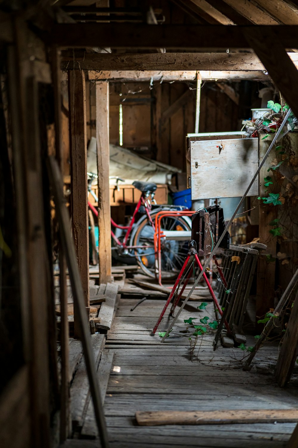 a room filled with lots of junk and wooden floors