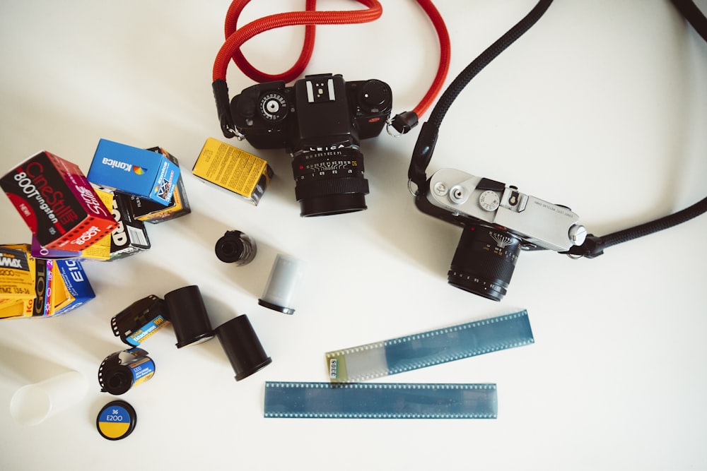 a white table topped with a camera and other items