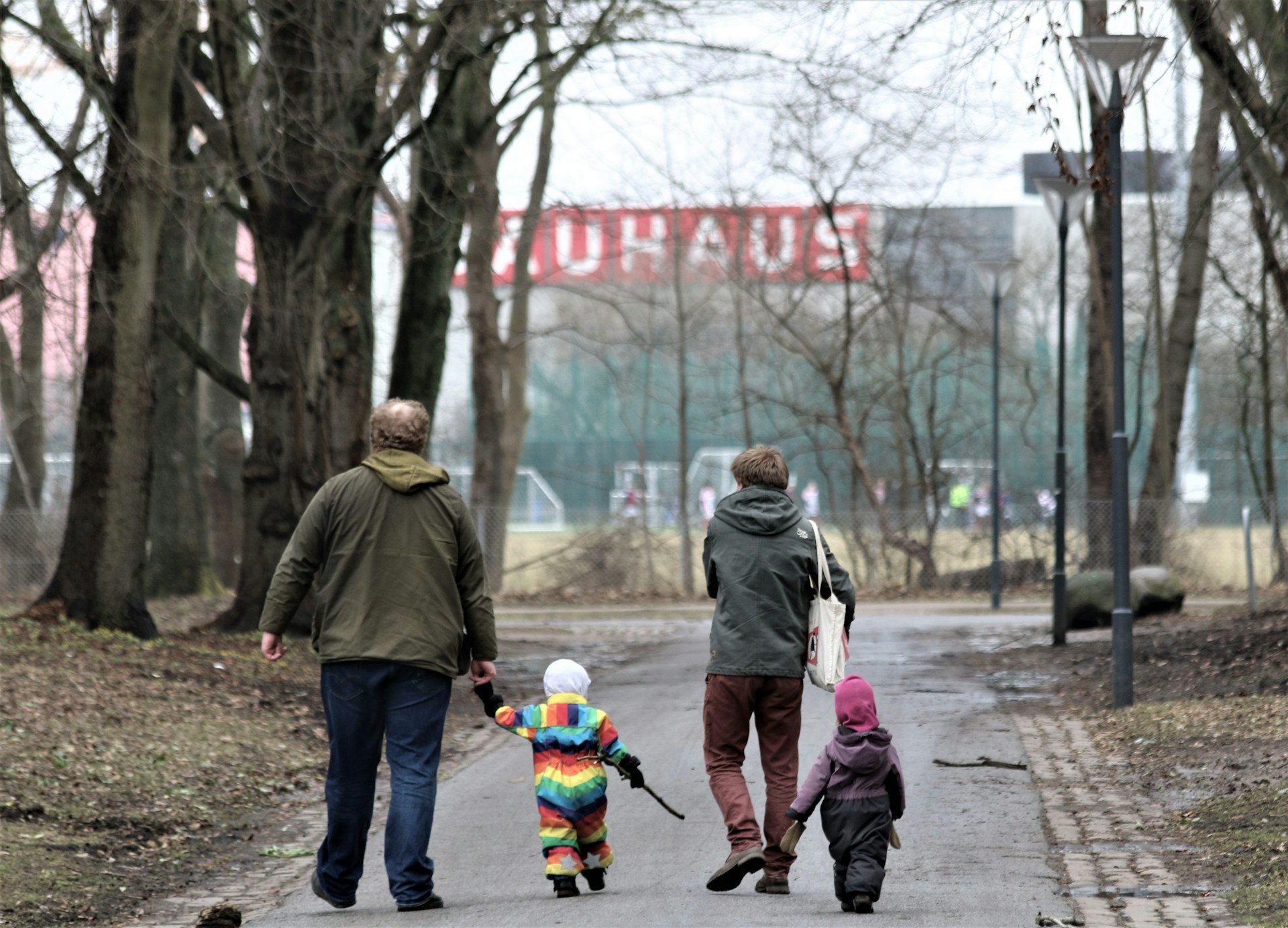 a family walking down a street holding hands