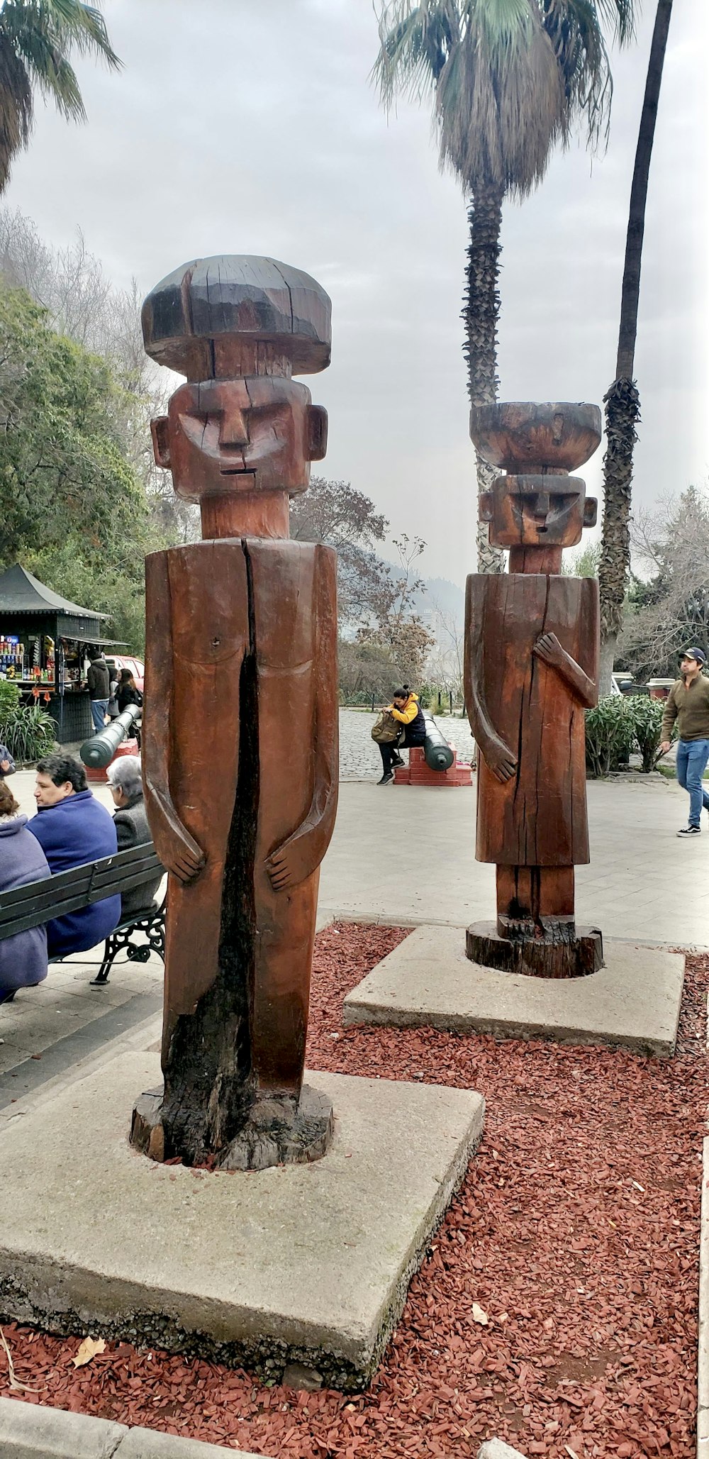 a couple of wooden statues sitting next to each other