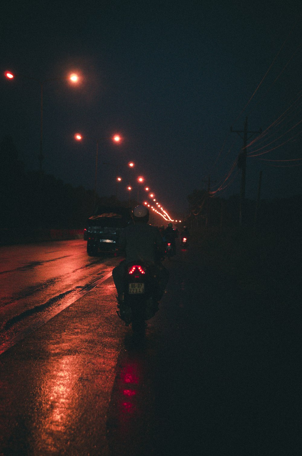 a motorcycle parked on the side of the road at night