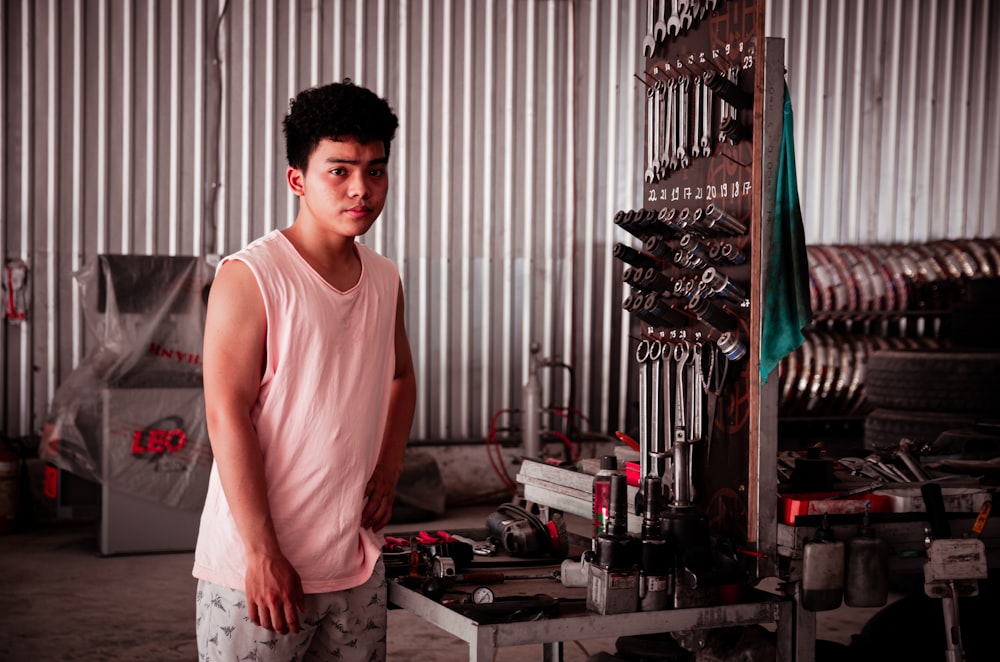 a young man standing in front of a machine