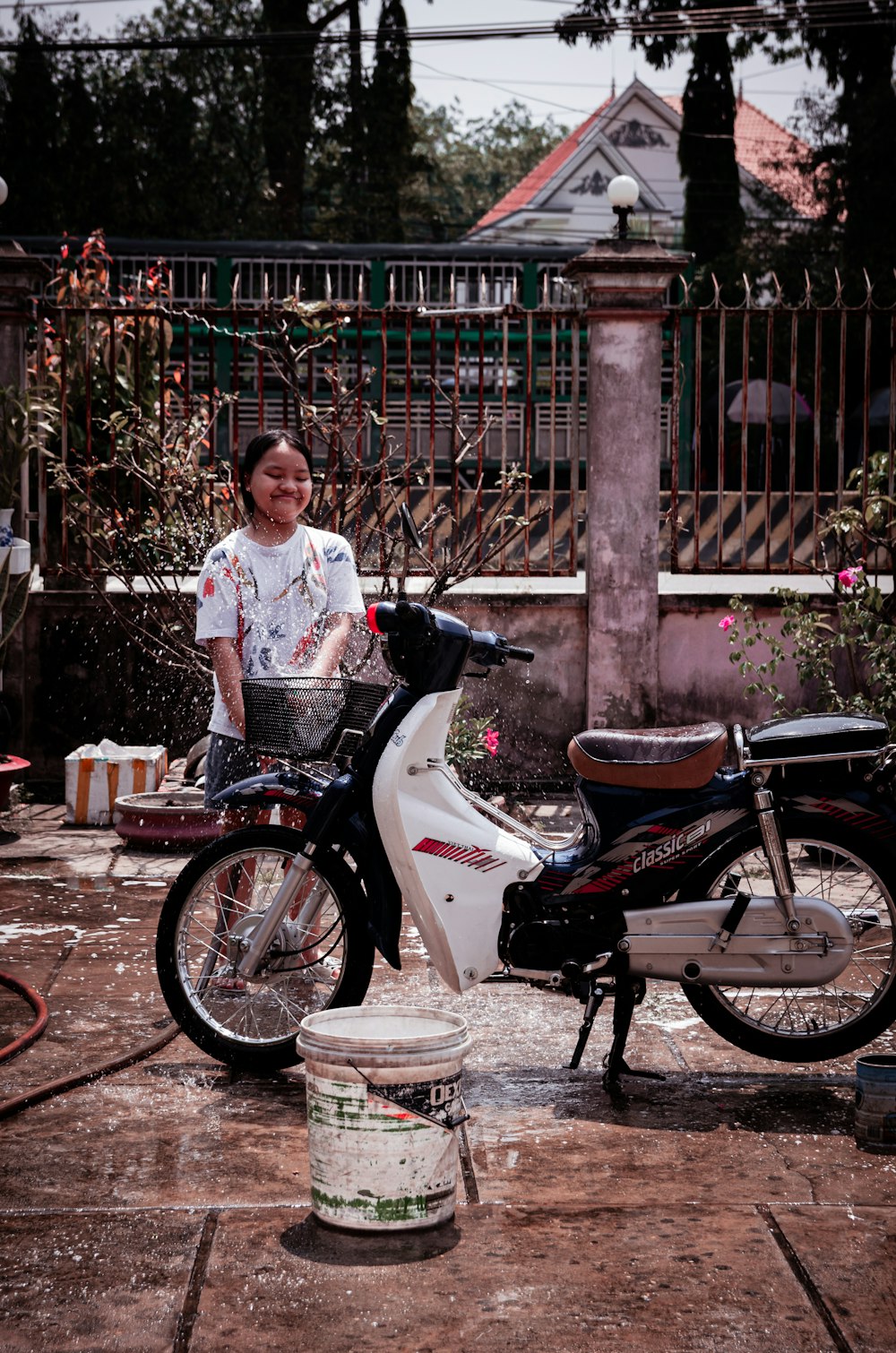 a woman standing next to a parked motorcycle