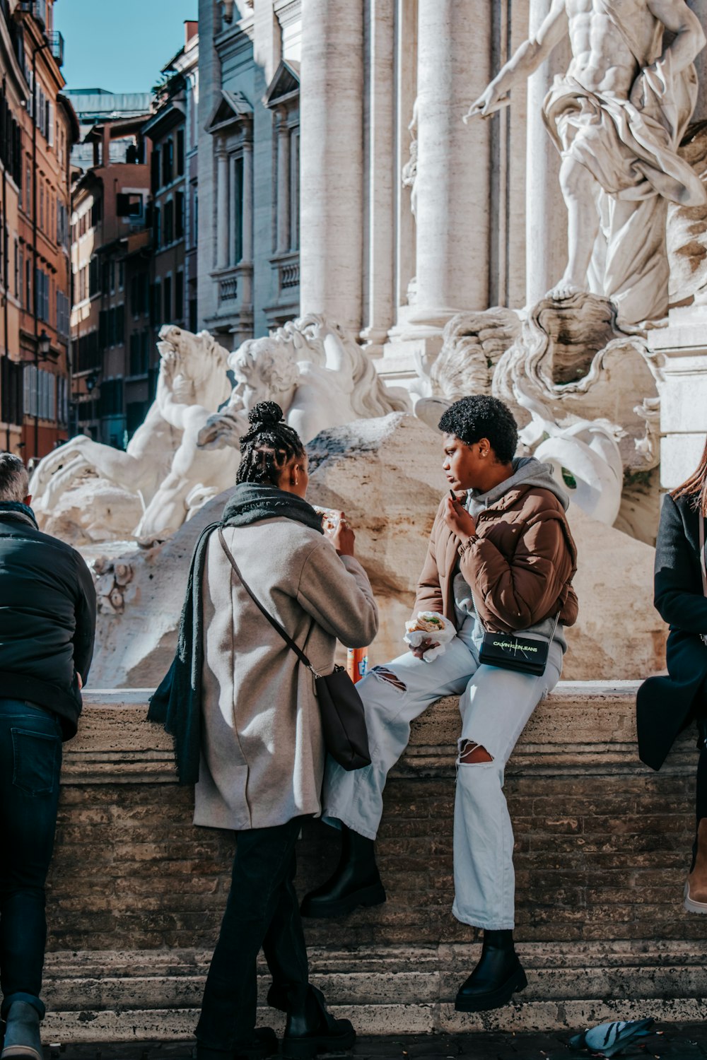 a group of people standing around a fountain