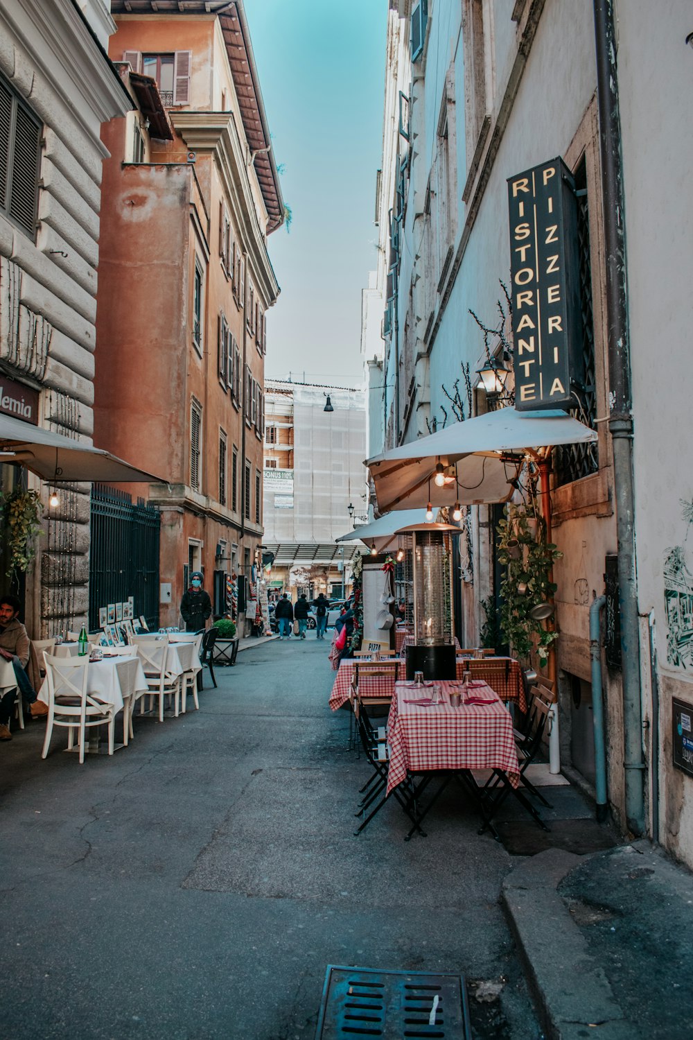 a group of people sitting at a table outside of a restaurant