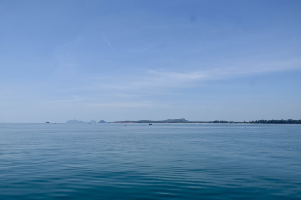 a large body of water with a small island in the distance