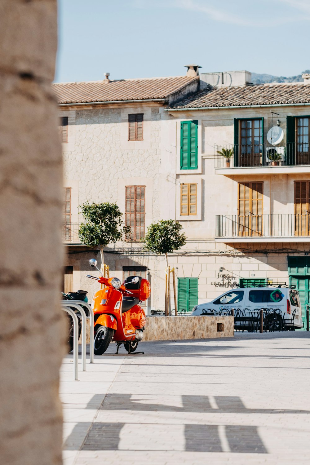 a motor scooter parked in front of a building