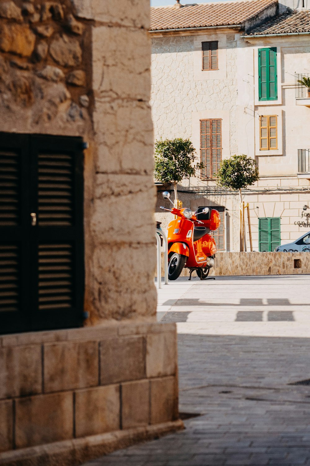 a motor scooter parked in front of a building