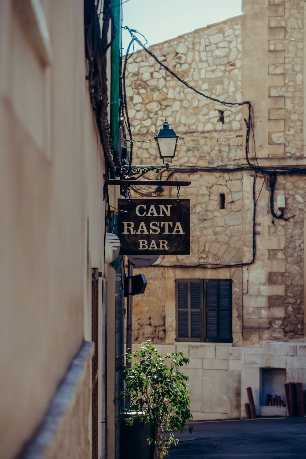 a narrow alleyway with a sign that says can rasta basil