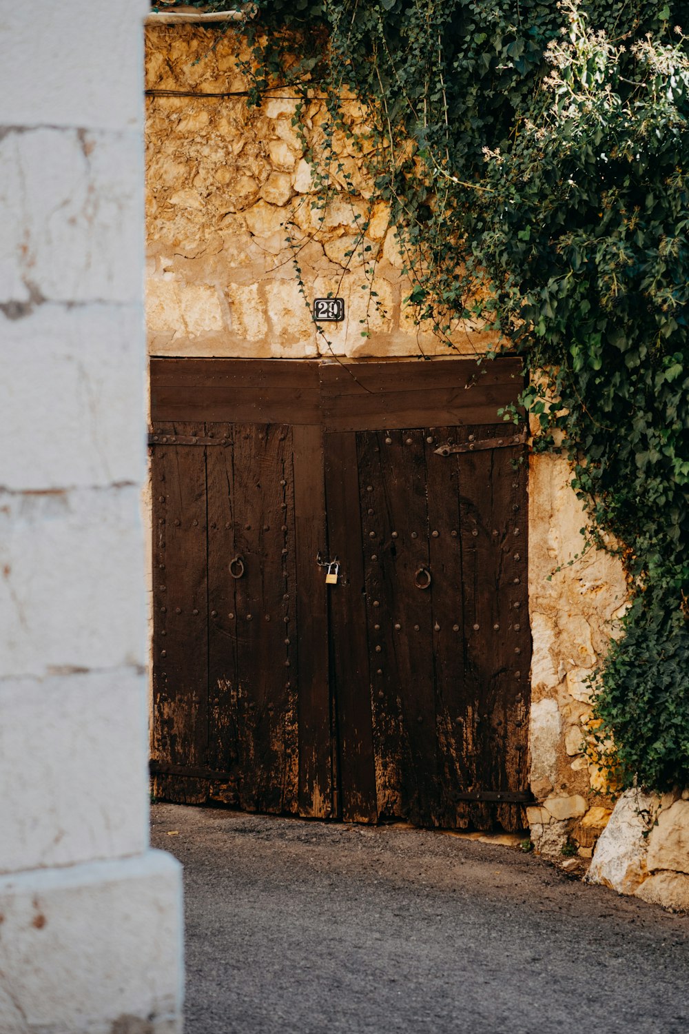 a wooden door with a brick wall behind it