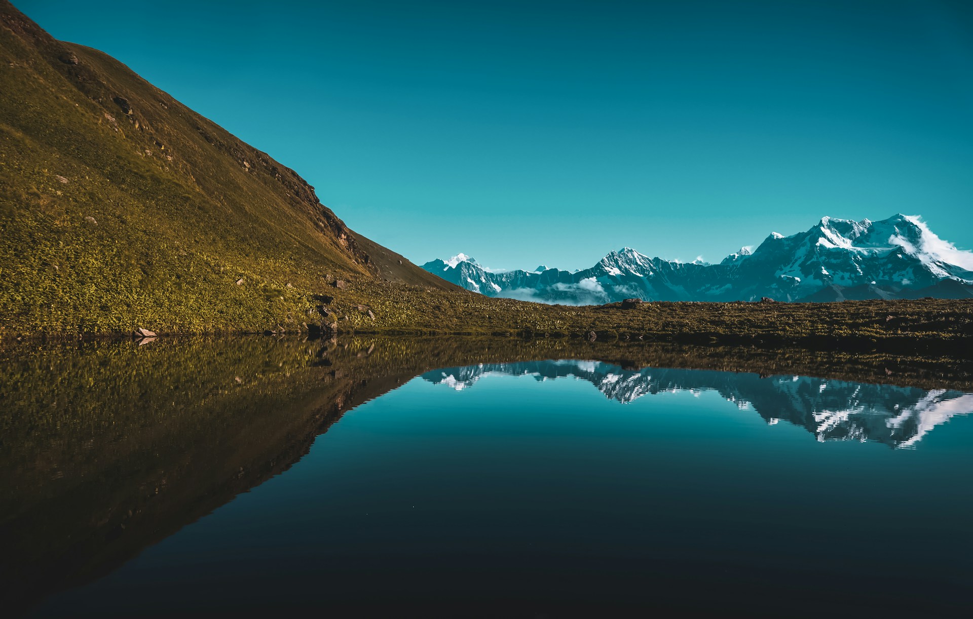 a large body of water with a mountain in the background