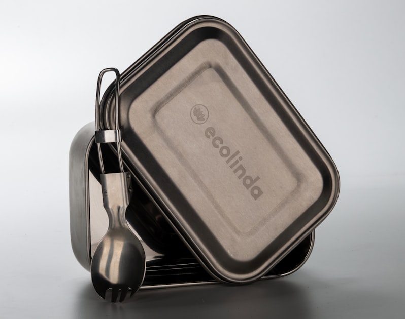 a couple of containers with spoons in them