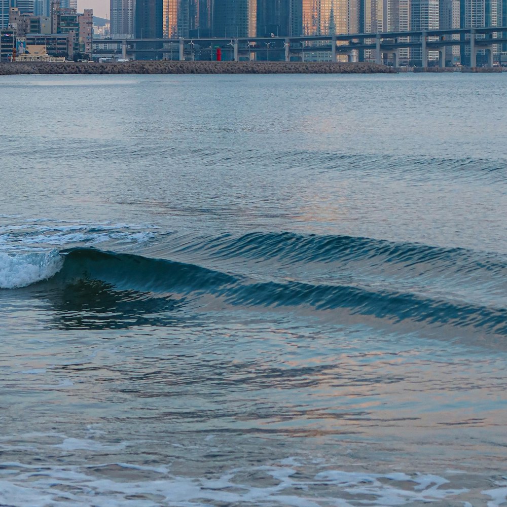 a man riding a wave on top of a surfboard