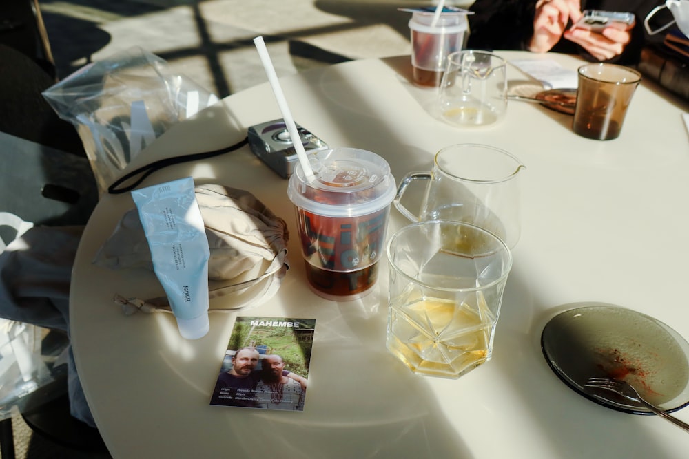 a table with drinks and a magazine on it