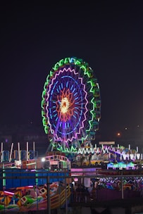 a ferris wheel lit up in the night sky