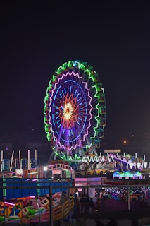 a ferris wheel lit up in the night sky