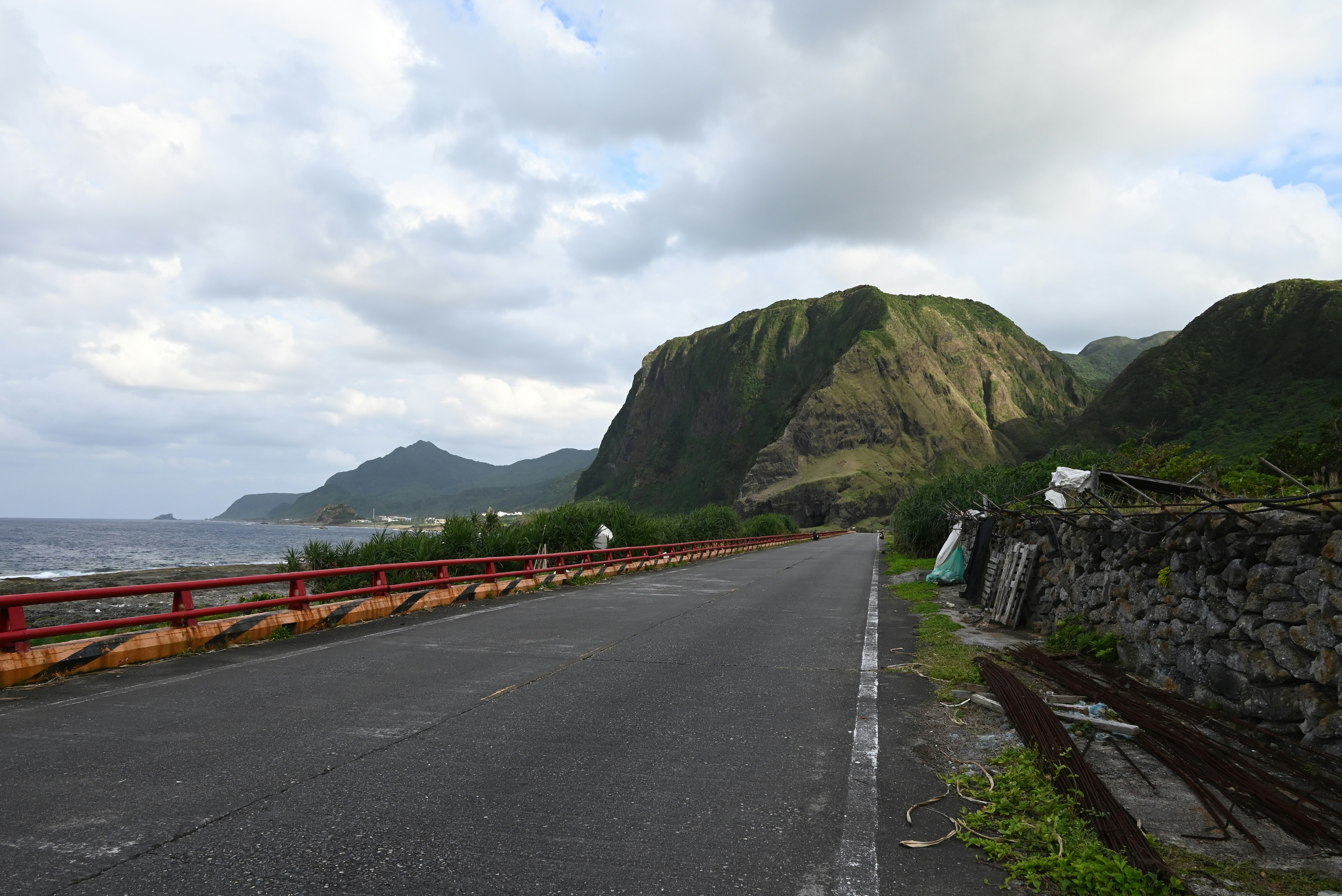 a long road with a mountain in the background