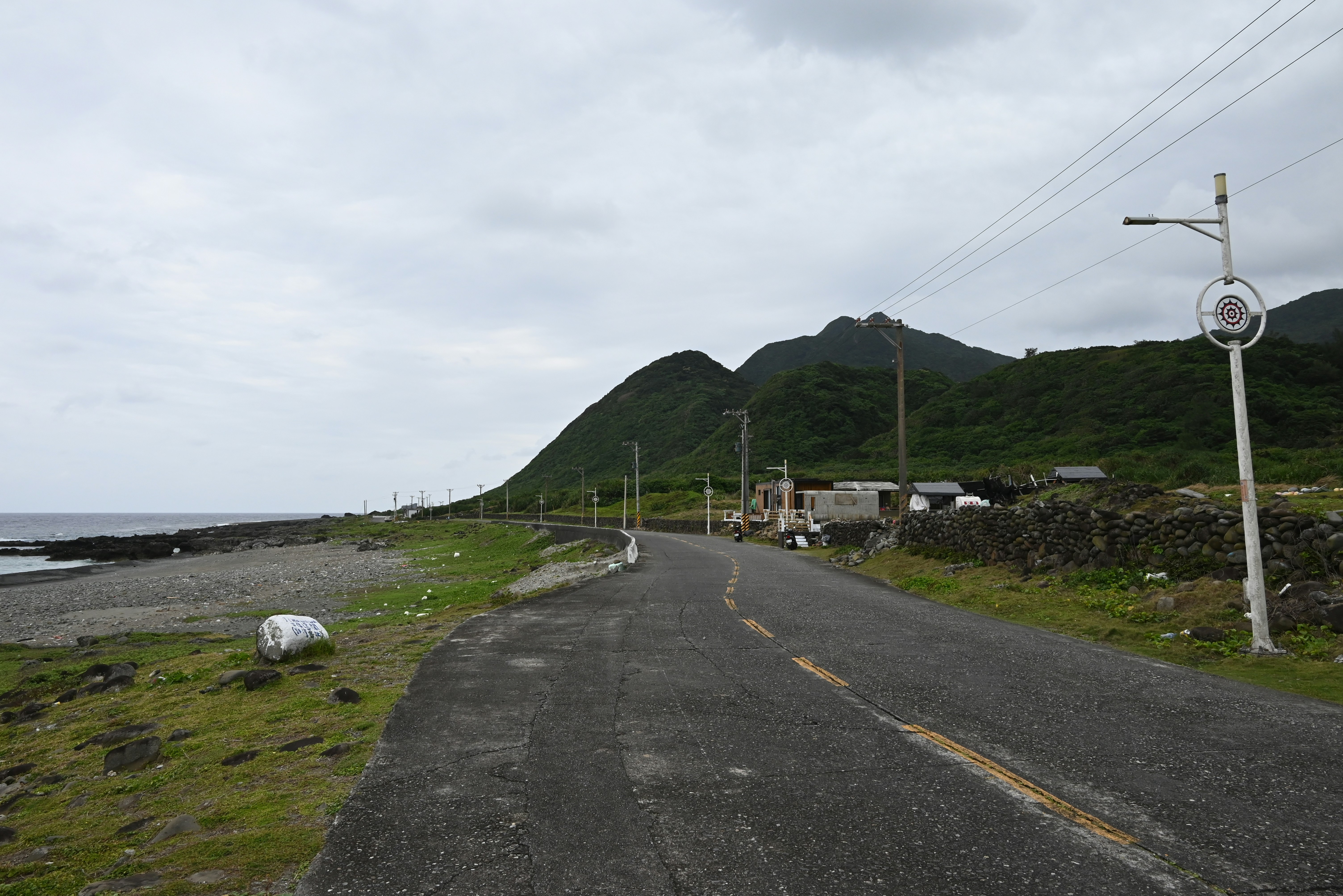 an empty road next to a body of water