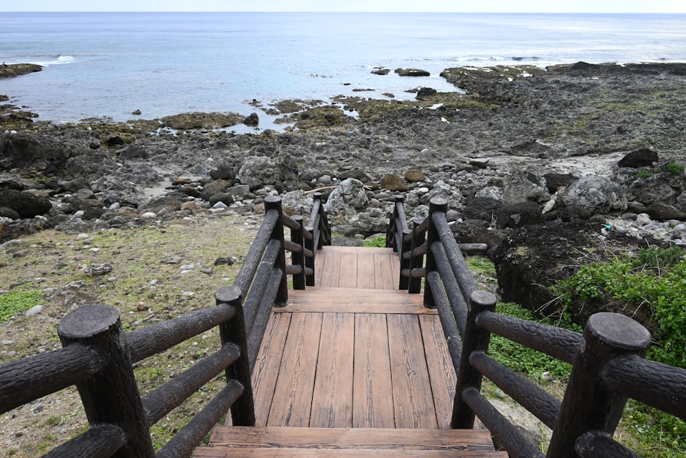 a wooden bridge with a view of the ocean